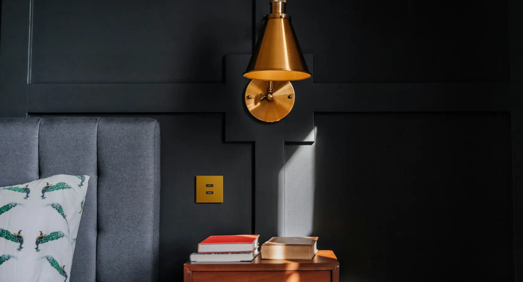 SUBLIME gold keypad beside a bed in a contemporary interior